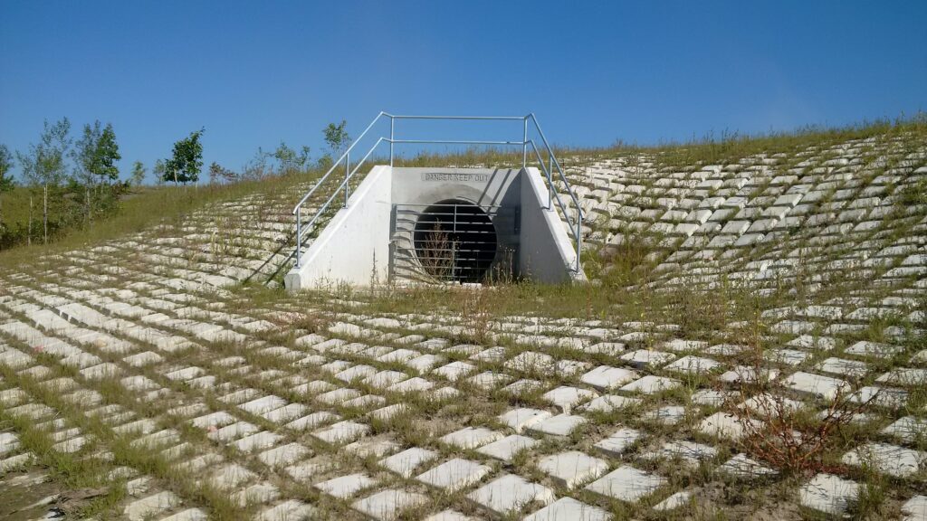 concrete drainage tunnels surrounded by concrete blocks on the ground